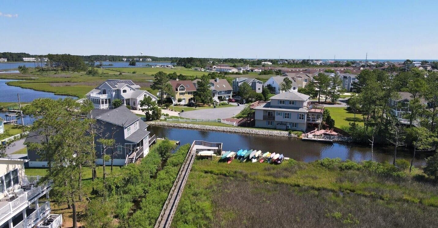 Stewards Watch - Community Waterfront Promenade - A picturesque wooden boardwalk and gazebo stretch over the marshy wetlands, providing a perfect spot for nature watching and enjoying sunset bay views.