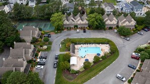 A residential area with a swimming pool, tennis courts, and houses. - 541D Hudson Avenue - Stewards Watch (Bethany Beach)