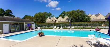Stewards Watch - Neighborhood Swimming Pool - Residents enjoy a refreshing L-shaped outdoor pool surrounded by a spacious sun deck, perfect for a relaxing afternoon away from the beach.