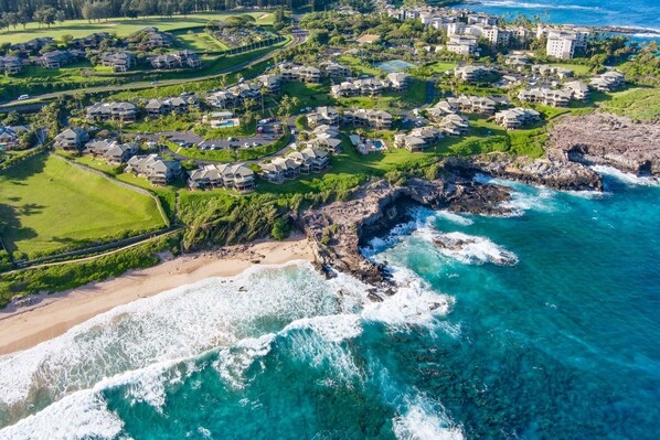 An aerial view of a coastal resort with beachfront properties, a rocky shoreline, and clear blue waters. - Kapalua Bay Villa 32g4 1 Bedroom Villa by RedAwning (Lahaina)