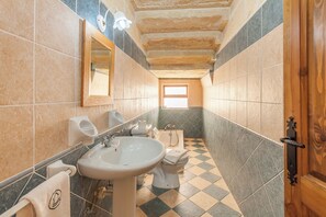 A bathroom with a sink, toilet, and bathtub.
