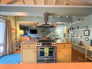 Enjoy cooking in this well-equipped kitchen with a central island, stainless steel stove, and oven.
