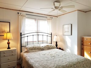Cozy retreat with a single bed, nightstand, and dresser, perfect for a comfortable stay.