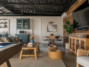A modern living room with a pool table, dining area, and kitchen. - 10 Bedroom / Pool / Hot tub / Pickleball / Firepit (Dripping Springs)