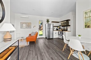 A modern kitchen with a stainless steel refrigerator, white cabinets, and a microwave. - 10 Bedroom / Pool / Hot tub / Pickleball / Firepit (Dripping Springs)