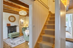 A staircase with wooden steps and a white door leading to a bathroom.