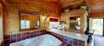 Quaint cabin overlooking the creek below and wetlands in the valley basin.