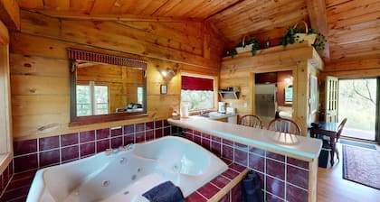 Quaint cabin overlooking the creek below and wetlands in the valley basin.