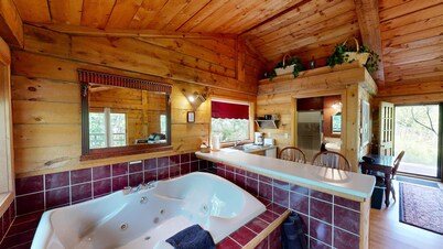 Quaint cabin overlooking the creek below and wetlands in the valley basin.