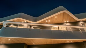 A modern building with a curved facade and multiple levels.