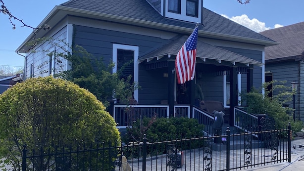 A two-story house with a front porch, a small garden, and a black metal fence. - 1890 Graystone Cottage behind Historic Home short walk to Downtown & Whiskey Row (Prescott)