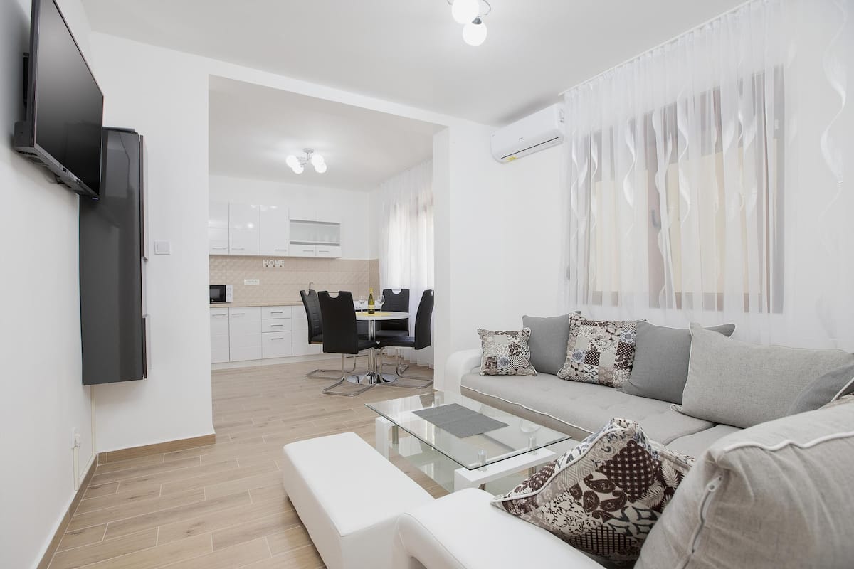 Apartamento conforto, vista para o jardim | Área de estar | TV de tela plana 30 polegadas com canais a cabo, TV