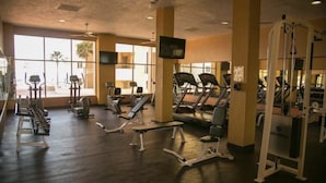 A gym with treadmills, elliptical machines, and weight stations. - Beachfront Lower Floor Luxury Condo (Puerto Peñasco)