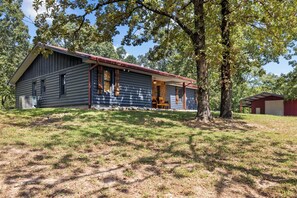 Cozy cabin-style building with a front porch and well-manicured lawn.