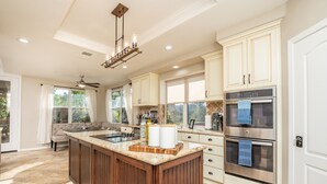 A spacious kitchen with a large island, modern appliances, and ample natural light.