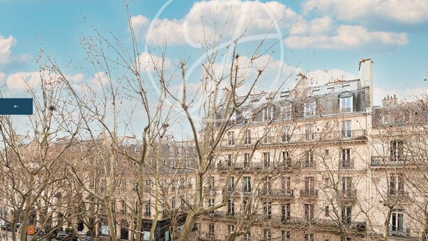 A multi-story building with a classic architectural style, featuring numerous windows and balconies. - Charming apartment in the heart of Saint-Germain (Paris)