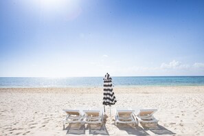 On the beach, sun-loungers, beach towels