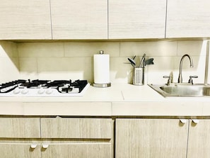 Fridge, microwave, coffee/tea maker, cookware/dishes/utensils