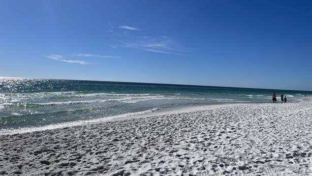 A beach with a sandy shore and a clear blue sky. - Panama City Beach Getaway | Games | Sleeps 8 |Pets (Panama City Beach)