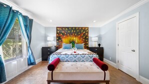 A bedroom with a large bed, a decorative wall piece, and a view of the outdoors. - Welcome to the Farm House! Excellent Location, Pet Friendly! (Windermere)