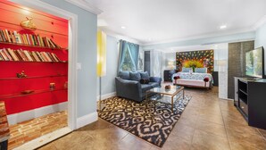 A modern living room with a sofa, coffee table, and a bookshelf filled with books. - Welcome to the Farm House! Excellent Location, Pet Friendly! (Windermere)