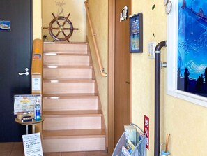 A staircase with a wooden handrail and a sign with information. - Nonsmoking Twin Happiness Owl Room 205 / Shimajiri-gun Okinawa (Shimajiri-gun)