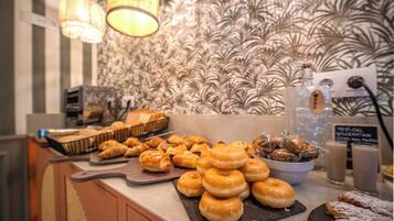 A breakfast buffet with pastries and beverages.