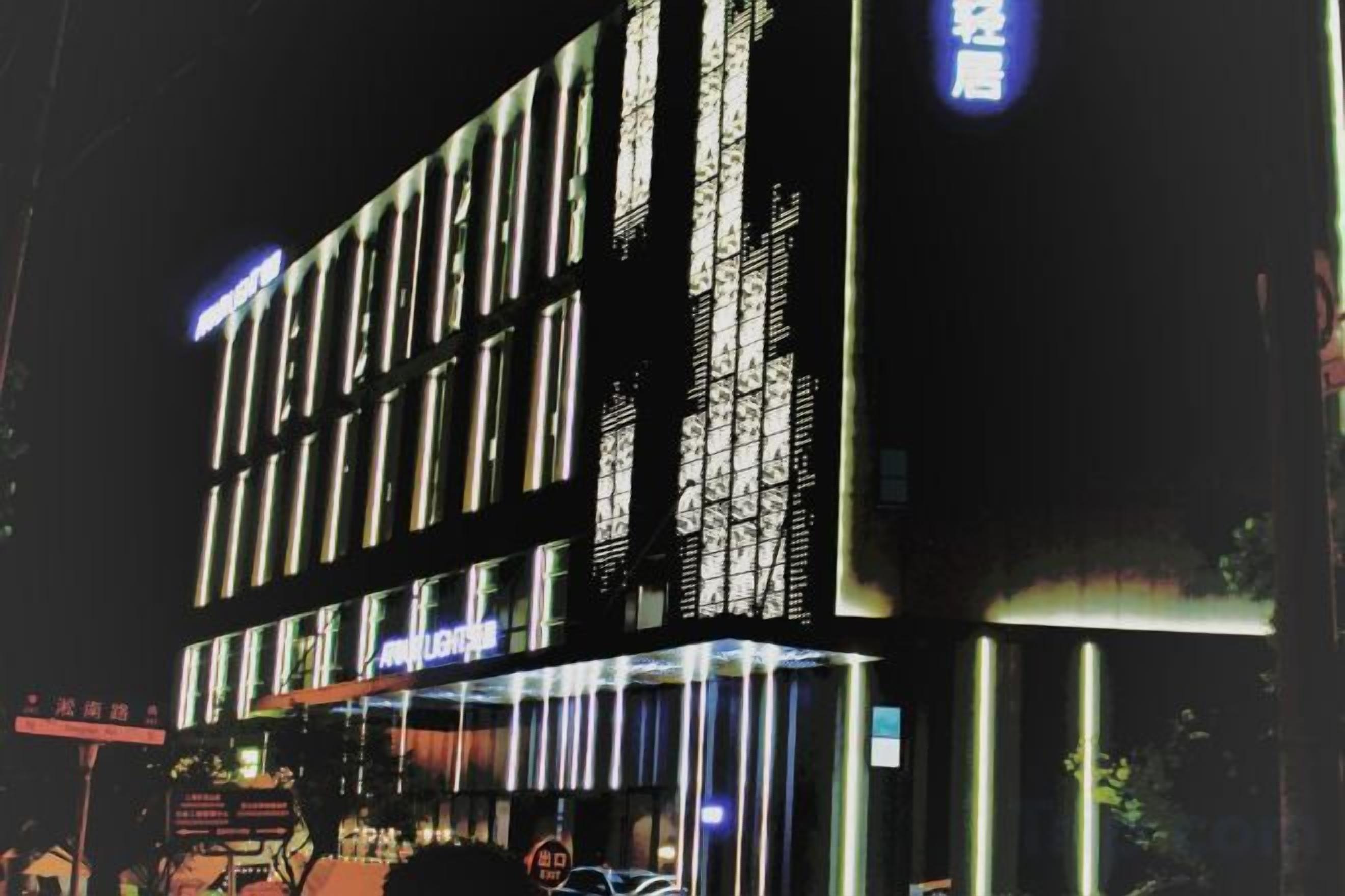 A multi-story hotel with illuminated signage and a modern facade.