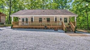 A two-story building with a covered porch, stone foundation, and a gravel driveway. - Fish, Hike & Explore! Family Tamassee Getaway (Tamassee)