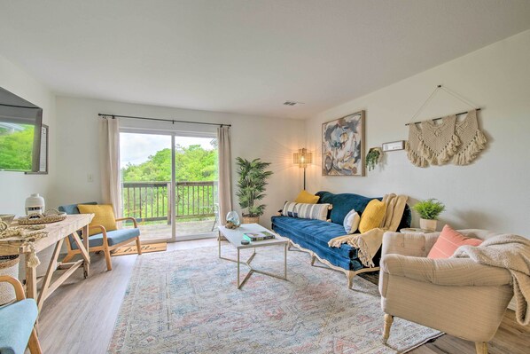 A cozy living room with a sofa, coffee table, and a dining area with a table and chairs.