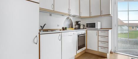 Fridge, stovetop, dishwasher, coffee/tea maker