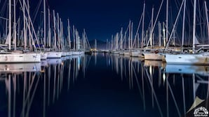 A marina at night with numerous sailboats docked in calm waters. - Mykonut Erna Apart Hotel (Fethiye)