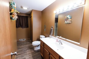 Combined shower/bathtub, towels, toilet paper