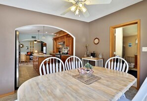 Enjoy meals in the spacious dining area with a round table and comfortable chairs.