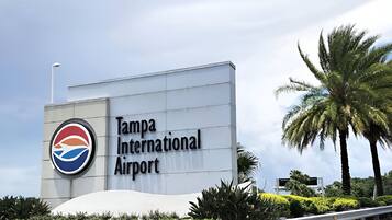 A sign for Tampa International Airport with a logo and the name of the airport.