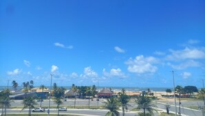 A coastal view with a beach, palm trees, and a restaurant named "RESTAURANTE & BAR DJUTA". - POUSADA MORADAS (Aracaju)