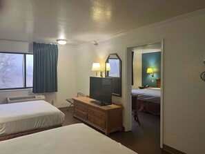 A hotel room with two beds, a desk with a TV, a dresser, and a window with curtains. - Motel 6 Portland, IN (Portland)