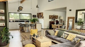 A modern living space with a kitchen, dining area, and seating area.