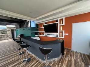 Enjoy a meal at the bar counter with a flat-screen TV and wine cooler.
