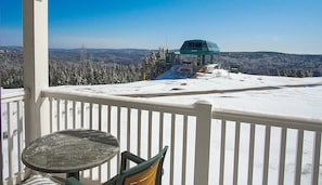 Enjoy breathtaking views of the surrounding mountains from this cozy balcony.