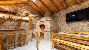 A rustic stone interior with wooden benches and a fireplace. - Pet friendly home in Benkovac (Benkovac)