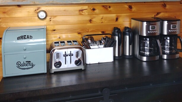 A kitchen counter with a vintage toaster, a bread box, and a coffee maker. - Eastern Beacon Inn Room 3 (Lubec)