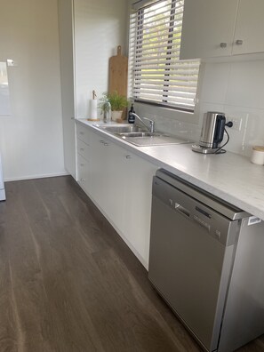 Enjoy cooking in this well-equipped kitchen with a sink and dishwasher.