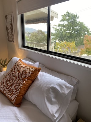 Enjoy a peaceful retreat with a comfortable bed and serene views from the balcony.