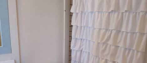 A bathroom with a toilet, a sink, and a shower curtain.