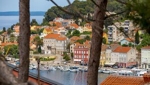 A coastal town with colorful buildings, a marina with boats, and a view of the sea. - Beach front apartment in Mali Losinj with WiFi (Mali Losinj)