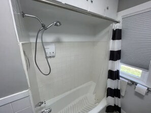 Combined shower/bathtub, hair dryer, towels, soap