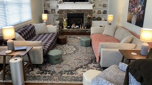 A cozy living room with a fireplace, comfortable seating, and a television above it. - Cozy Modern Cottage Style Home minutes from VT, RU, Christiansburg Aquatic Cente (Christiansburg)