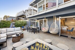 A modern outdoor patio with a fire pit, seating area, and a dining space. - Mission Point Buyout by AvantStay | Two Unit Buyout w/ Patio & Close to Beach! (San Diego)