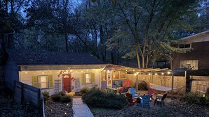 A backyard with a wooden deck, outdoor seating, and a barbecue area. - Fun w/Loft! Beach ~Nature Trails ~Grill~ Firepit ~Indiana Dunes National Park  (Gary)
